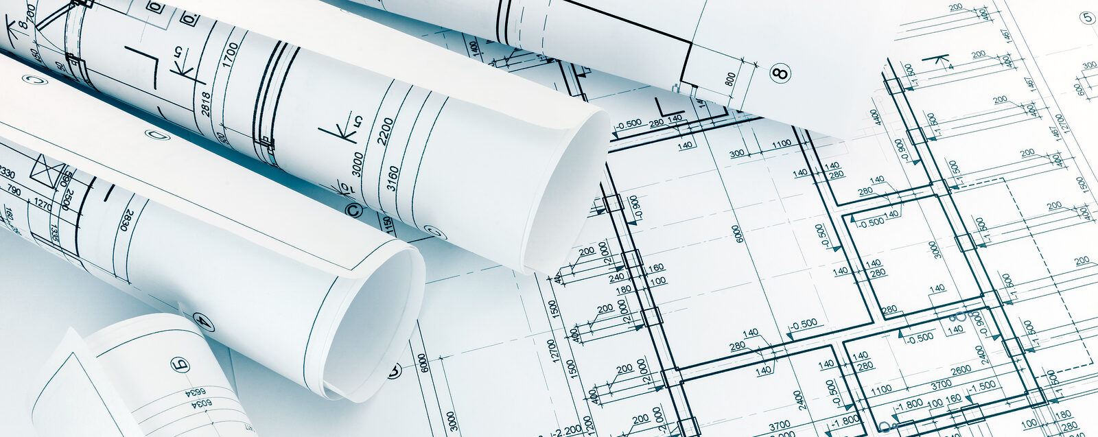 Rolls Of Architecture Blueprints With Floor Plan Drawing On Arch